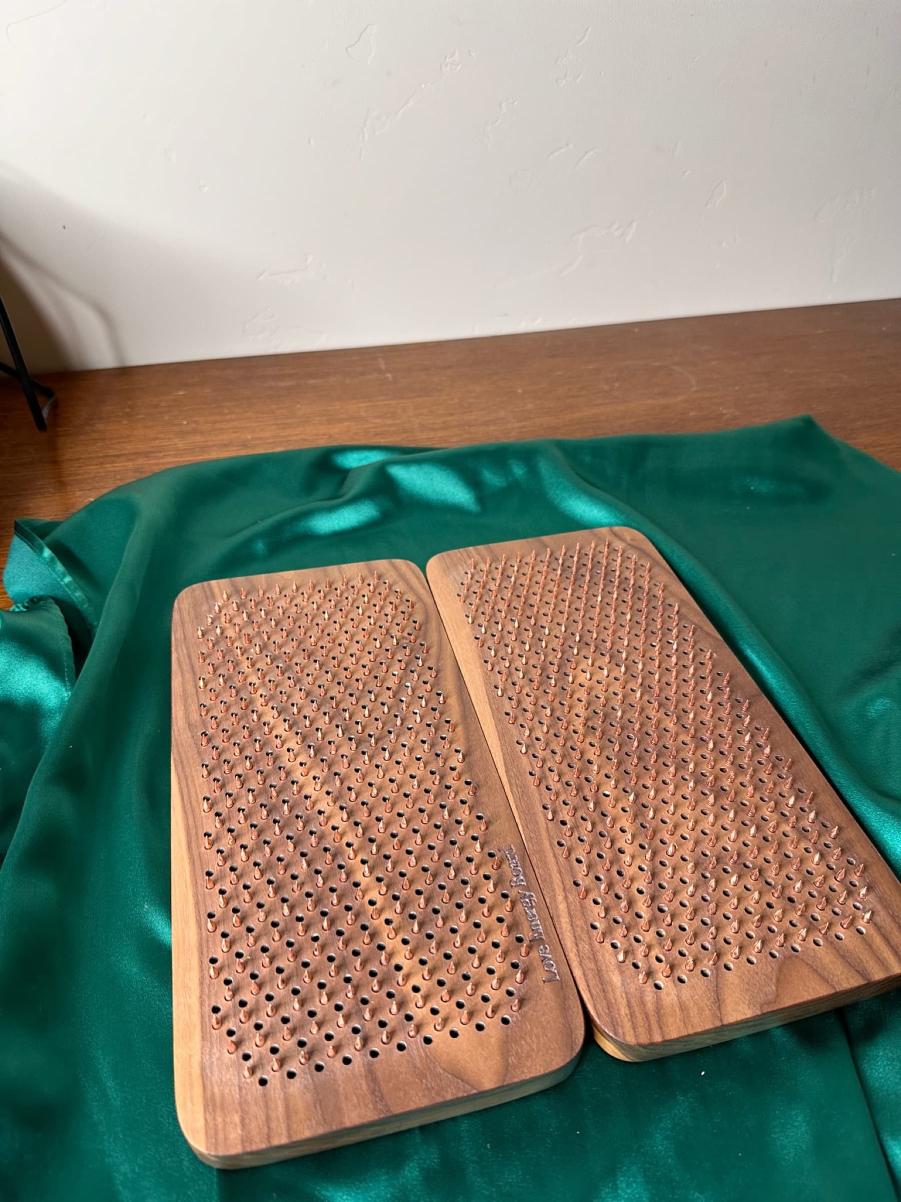 Still from the video guide: bare feet placed deliberately on the copper nail bed of a Love Energy Board, sunset light.